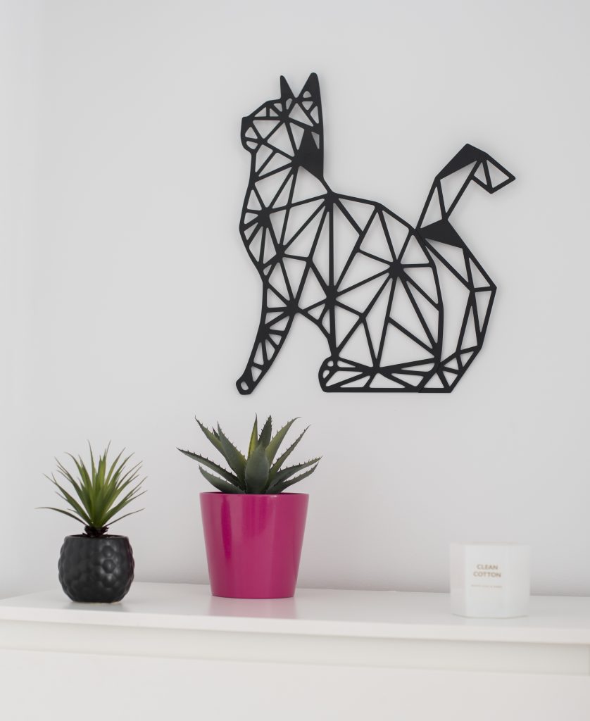 cat decoration with cacti and candles in drawer