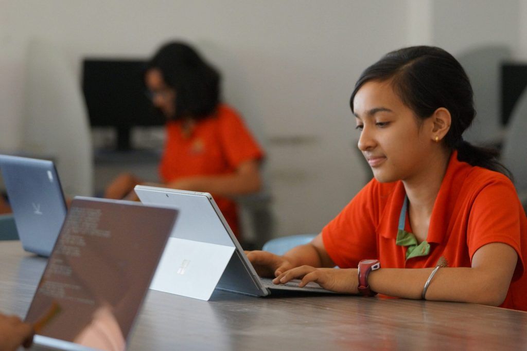 girl at school with a tablet learning to code