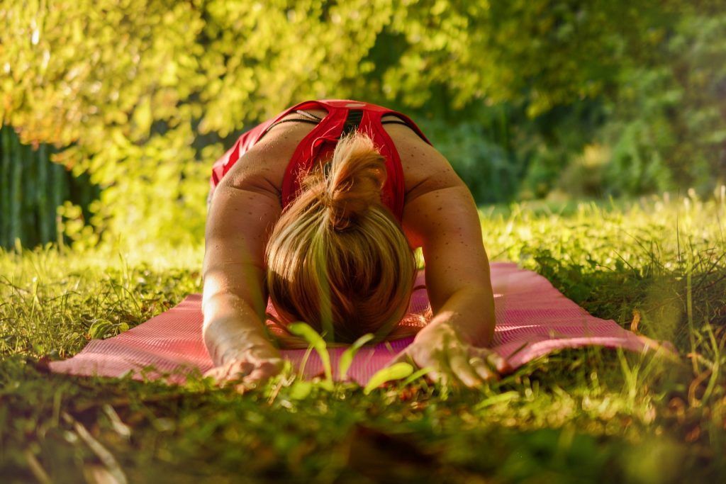 woman doing yoga in the park